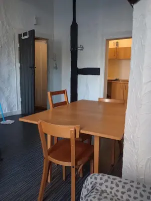 a wooden table and chairs in a room at Studio donceel in Liège