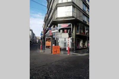 a building on a city street with a street sign at Studio donceel in Liège