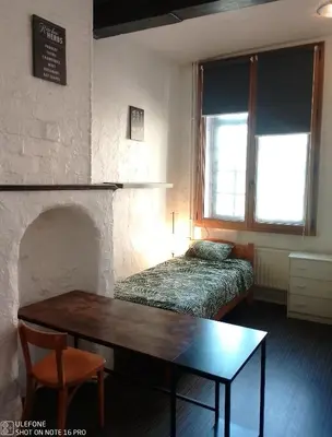 a room with a table and a bed and a table sidx sidx sidx at Studio donceel in Liège
