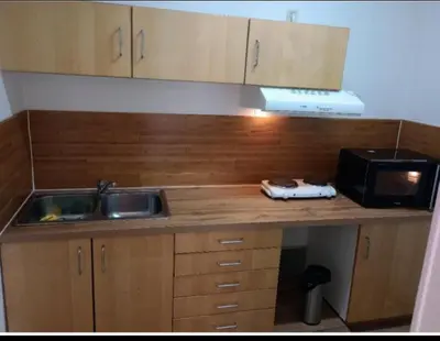 a kitchen counter with a sink and a microwave at Studio donceel in Liège