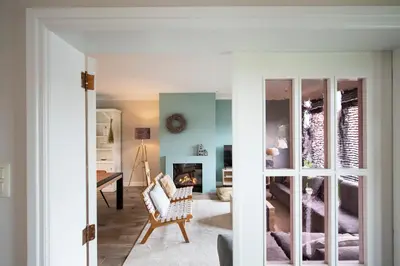 a living room with a couch and a fireplace at Huize Idalie in Bilzen
