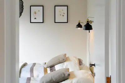 a living room with a couch and two pictures on the wall at Huize Idalie in Bilzen