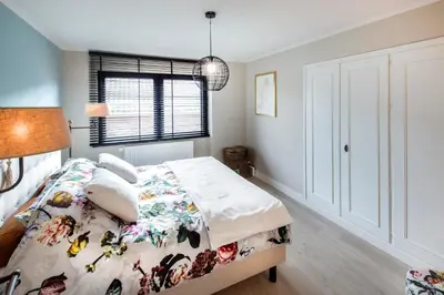 a bedroom with a bed and a window at Huize Idalie in Bilzen