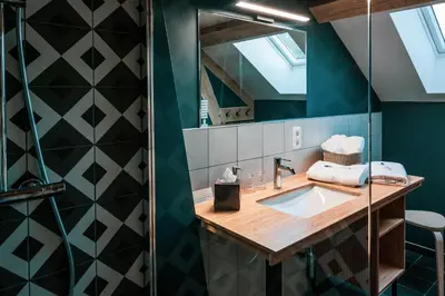 a bathroom with a sink and a mirror at Un air de bourlingueurs in Pepinster