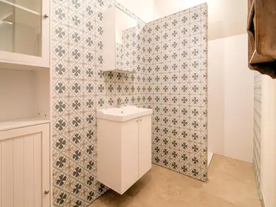 a bathroom with a toilet and a tiled wall at Bocholt Family Home, Bocholt in Bocholt