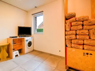 a laundry room with a washer and a pile of bread at Bocholt Family Home, Bocholt in Bocholt