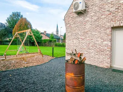 a brick building with a playground with a wooden swing at Bocholt Family Home, Bocholt in Bocholt