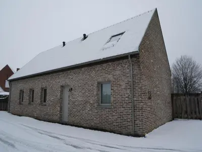 a brick building with a snow covered roof at Bocholt Family Home, Bocholt in Bocholt