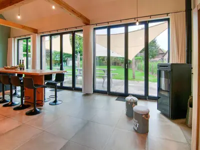a large kitchen with a table and chairs and windows at Bocholt Family Home, Bocholt in Bocholt