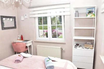 a room with two beds and a desk and a window at B&b La Villa Orchidées, breakfast included in Bassenge