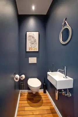 a bathroom with a white toilet and a sink at Au bois du Sart-Tilman in Sur le Mont