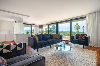 a living room with two couches and a table at Au bois du Sart-Tilman in Sur le Mont