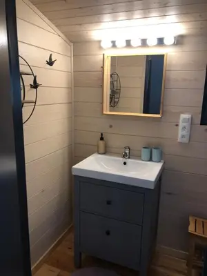 a bathroom with a sink and a mirror at Chalet Harmony in Zutendaal