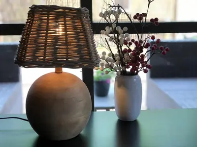 two vases on a table with a lamp and flowers at Chalet Harmony in Zutendaal