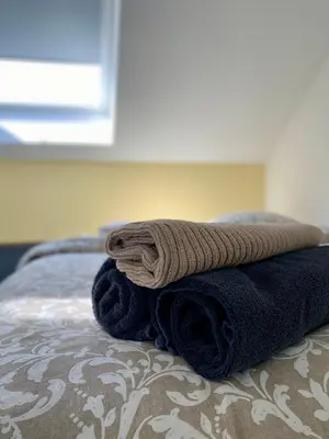a pile of towels sitting on top of a bed at Les gîtes du Broukay - Hirondelle in Bassenge