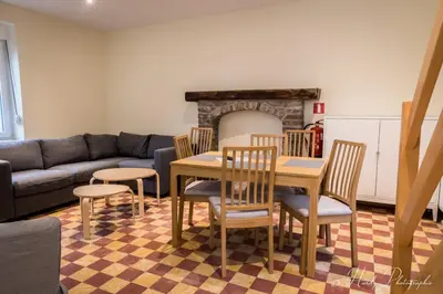 a living room with a table and chairs and a couch at Les gîtes du Broukay - Hirondelle in Bassenge