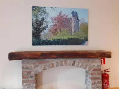 a painting of a castle above a fireplace at Les gîtes du Broukay - Hirondelle in Bassenge