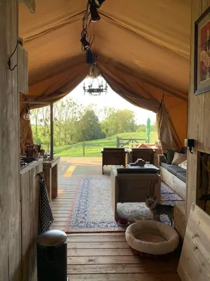 a room with a tent with a bed and a table at Le Relais d'Artagnan - relais équestre in Mortier