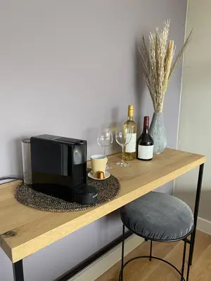 a table with a microwave and wine glasses on it at B&B Gellick in Lanaken
