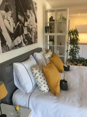 a bed with pillows on it in a room at Villa van Brienen - Studio in Dilsen-Stokkem