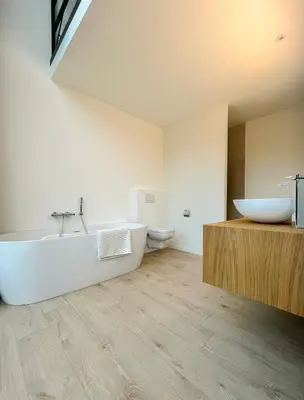 a bathroom with a tub and a sink and a toilet at de Bosch in Lummen