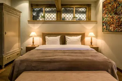 a bedroom with a large bed with two lamps at de Bosch in Lummen