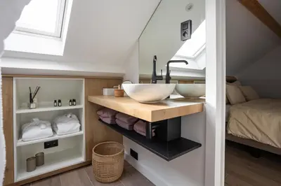 a bathroom with a sink and a bed at Luna Logies in Lanaken