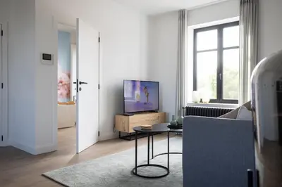 a living room with a tv and a couch at Luna Logies in Lanaken