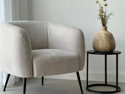 a vase sitting on a table next to a chair at Luna Logies in Lanaken