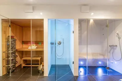 a bathroom with a shower with a glass door at Maison Noppius - Love Hotel in Liège
