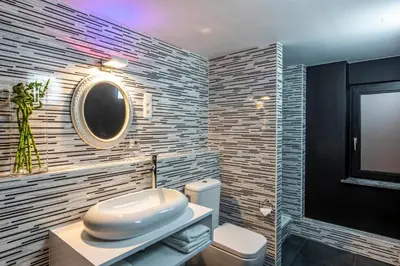 a bathroom with a white toilet and a mirror at Maison Noppius - Love Hotel in Liège