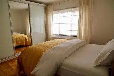 a bedroom with a bed and a large window at Ellé'Belle Oudsbergen 1-, 2- or 3-Bedrooms in Oudsbergen