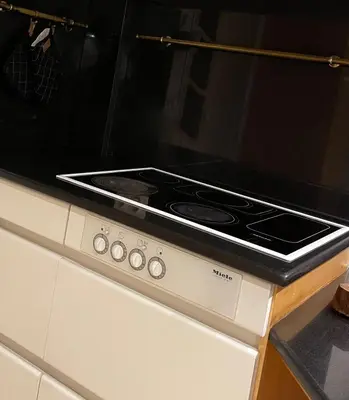 a stove top oven sitting on top of a kitchen counter at Ellé'Belle Oudsbergen 1-, 2- or 3-Bedrooms in Oudsbergen