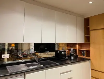 a kitchen with white cabinets and a sink at Ellé'Belle Oudsbergen 1-, 2- or 3-Bedrooms in Oudsbergen