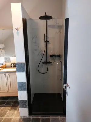 a shower with a glass door in a bathroom at B&B Bloonwinning in Hasselt