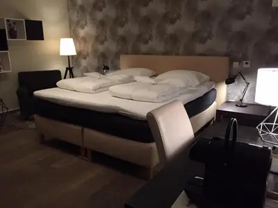 a bedroom with a large bed with white pillows at B&B Bloonwinning in Hasselt