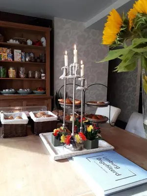 a table with a display of food and candles at B&B Bloonwinning in Hasselt