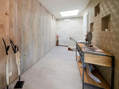 a hallway with a wooden wall and a table at Holiday home in Vise Richelle near town in Richelle