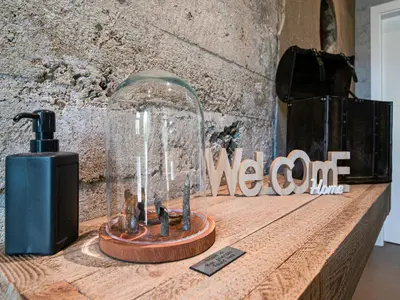 a glass jar on a wooden table next to a sign at Holiday home in Vise Richelle near town in Richelle