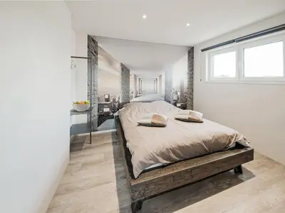 a bedroom with a large bed and a window at Holiday home in Vise Richelle near town in Richelle