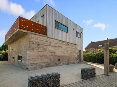 a house with a wooden wall with a roof at Holiday home in Vise Richelle near town in Richelle