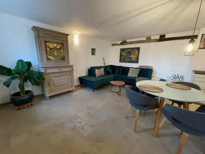a living room with a couch and a table at Bellerose Maison de Greunebennet in Plombières