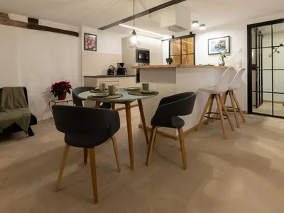 a dining room and kitchen with a table and chairs at Bellerose Maison de Greunebennet in Plombières