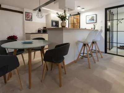 a kitchen and dining room with a table and chairs at Bellerose Maison de Greunebennet in Plombières