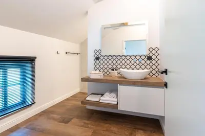 a bathroom with a sink and a mirror at B&B Punto Vélo in Zutendaal