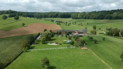 an aerial view of a farmhouse in a field at Hoeve Espewey Cottage in Hombourg
