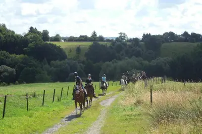 a group of people riding horses down a dirt road at Hoeve Espewey Cottage in Hombourg