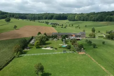 an aerial view of a farmhouse in a field at Hoeve Espewey Cottage in Hombourg