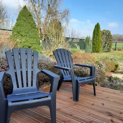 two chairs sitting on top of a wooden deck at Kanne: charming house between nature and shopping in Kanne