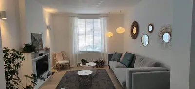 a living room with a couch and a tv at Kanne: charming house between nature and shopping in Kanne